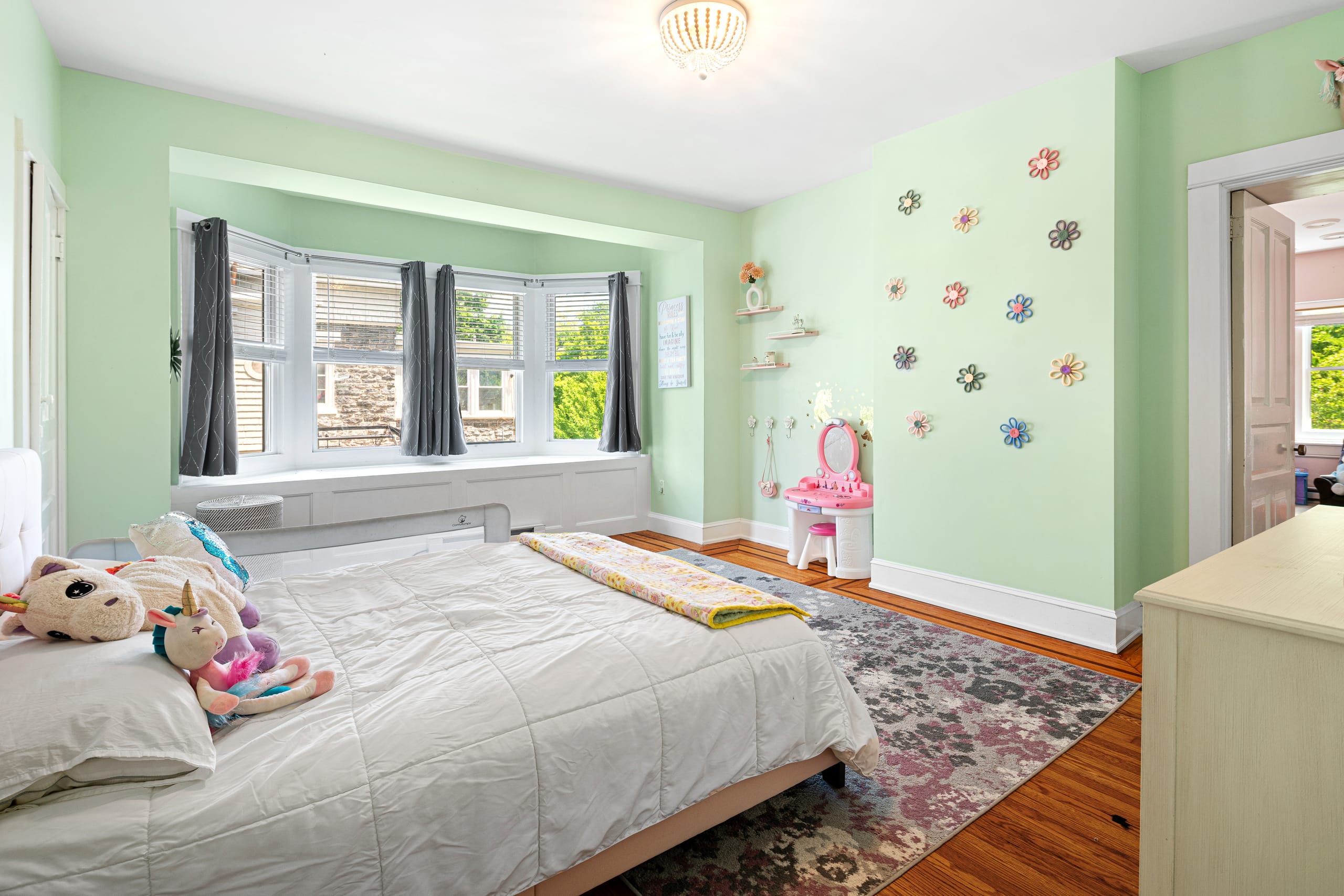 Bright mint bedroom with bay window
