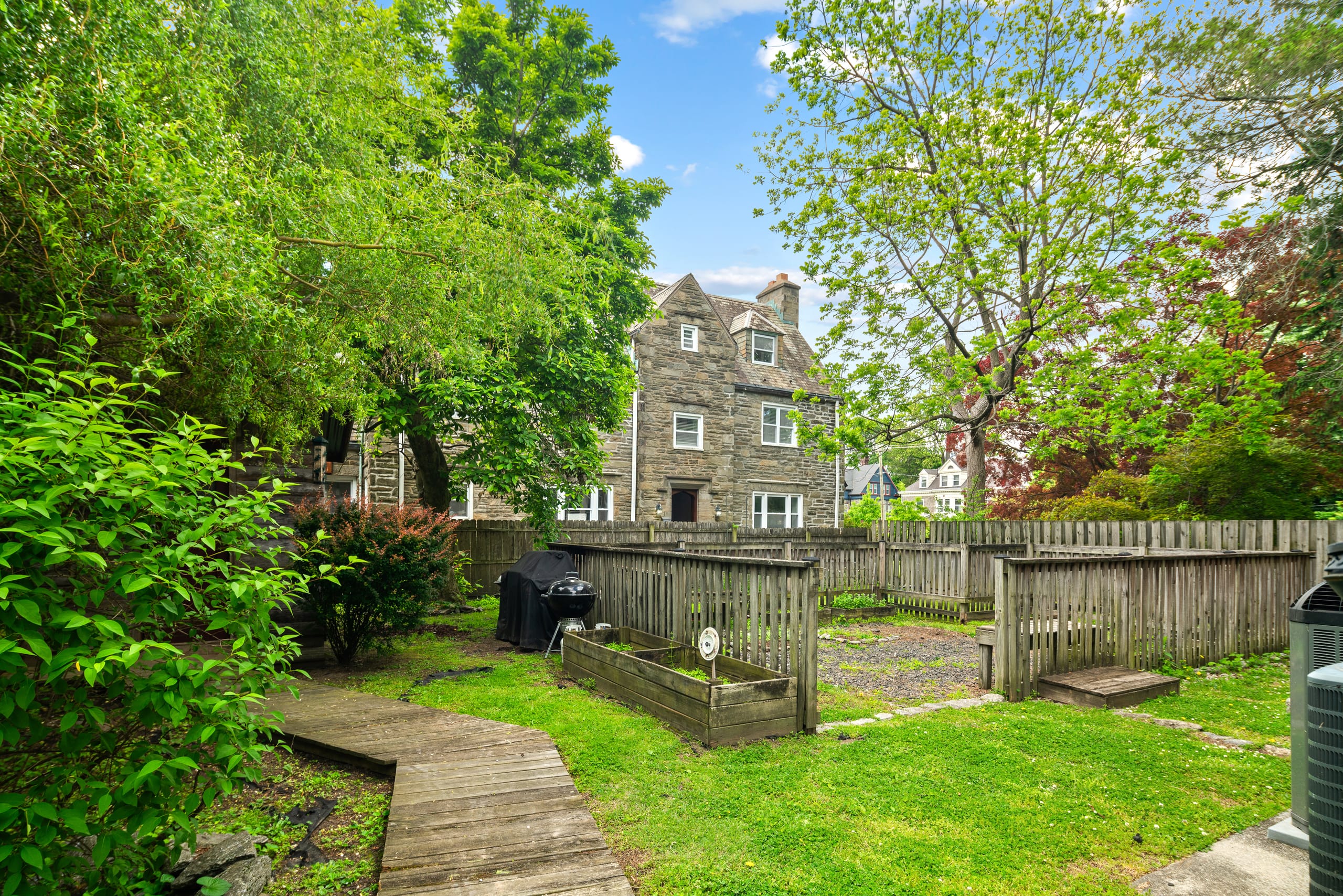 Raised garden beds with house behind