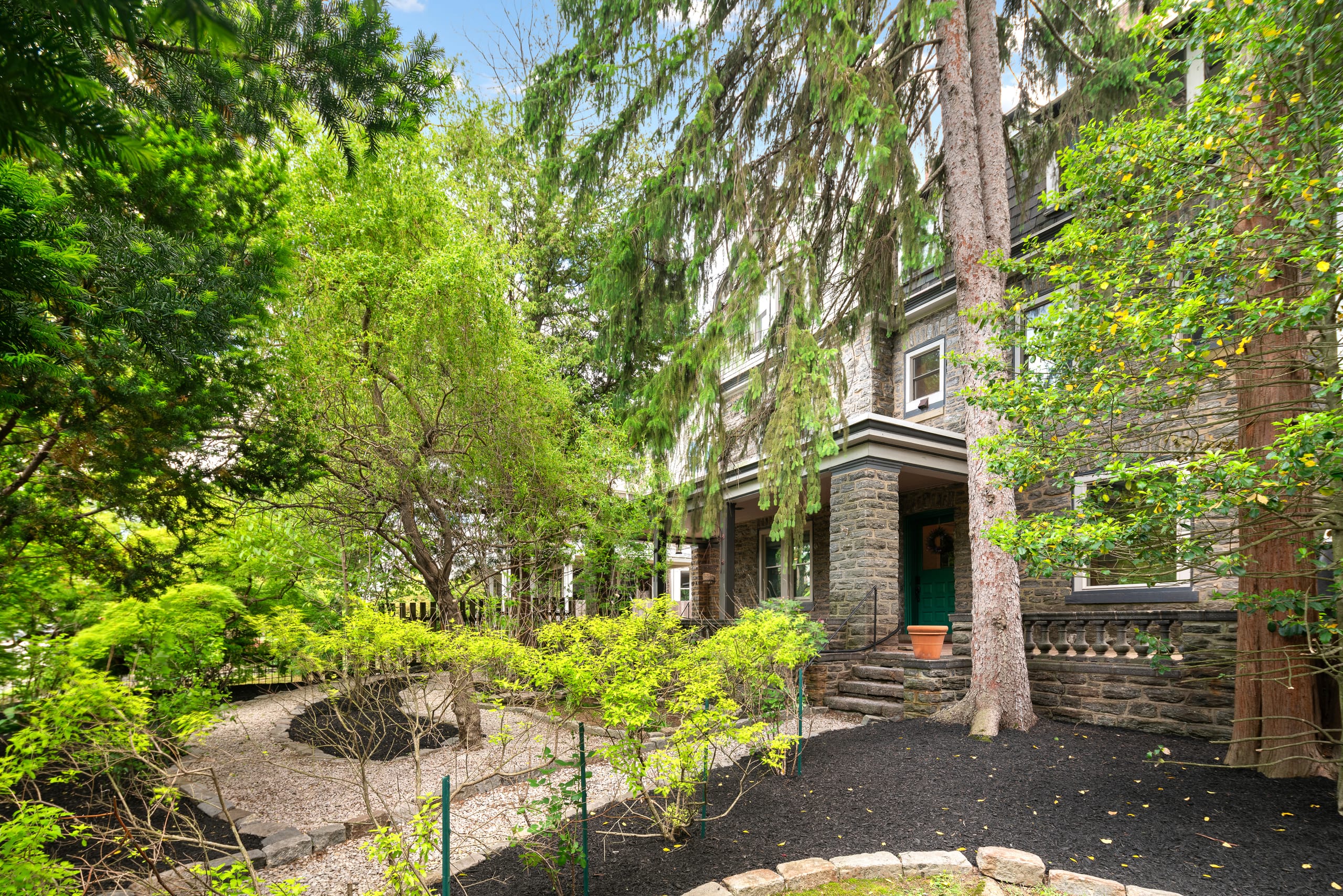 Front entry through mature landscaping