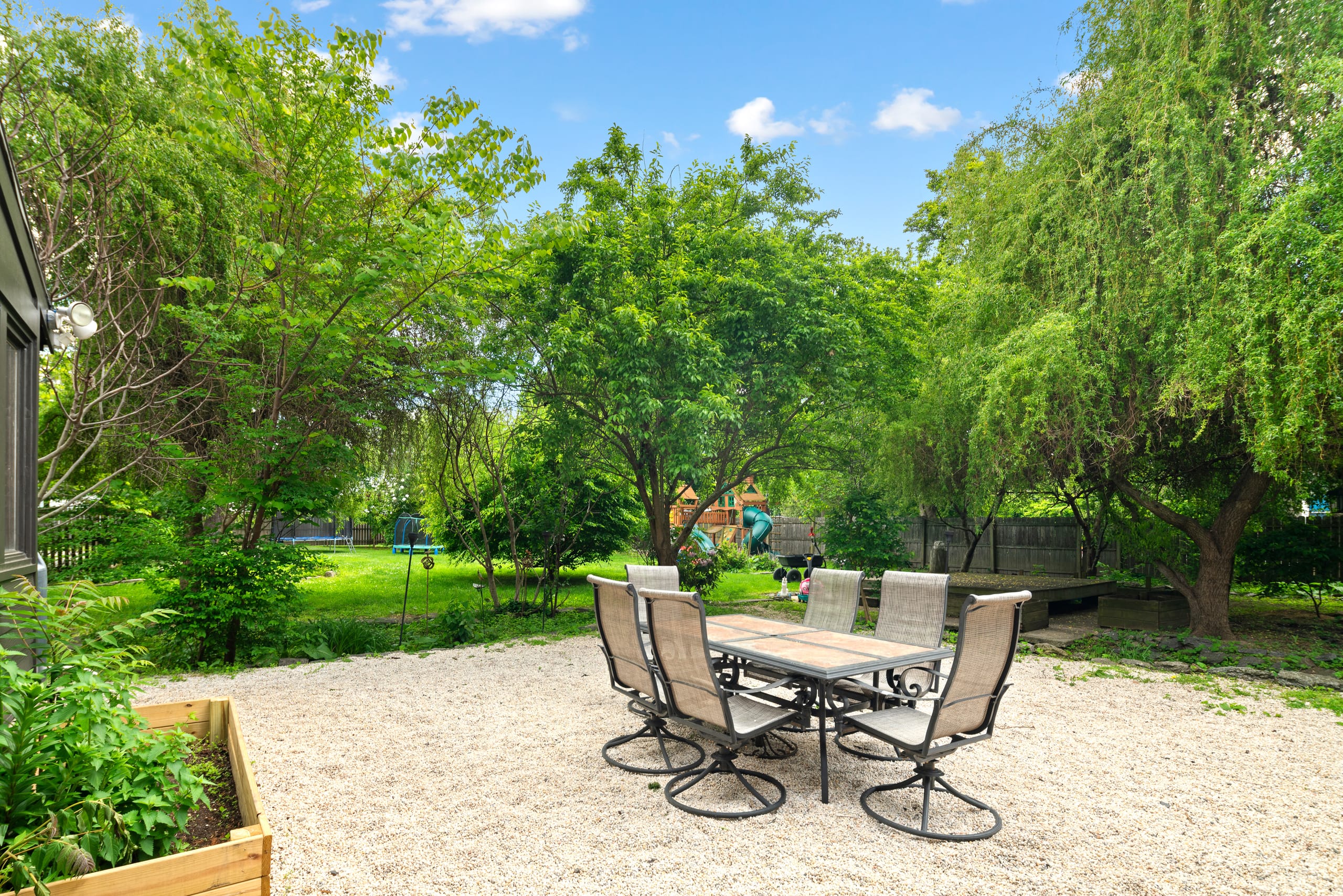 Garden dining area set among mature trees